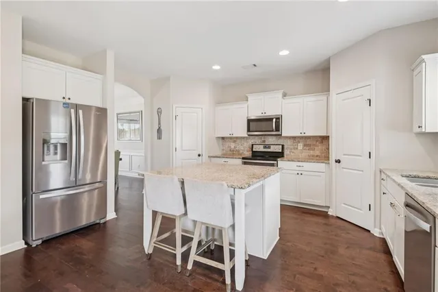 a kitchen with stainless steel appliances a refrigerator stove microwave and cabinets