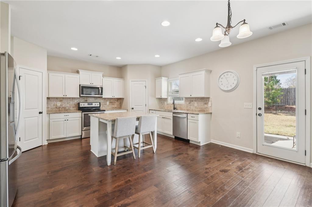 1120 Red Bud Circle Villa Rica, GA 30180 - Photo 10 of 31 a kitchen with a sink cabinets and wooden floor