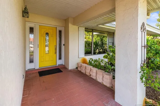a kitchen with stainless steel appliances granite countertop a sink and a refrigerator