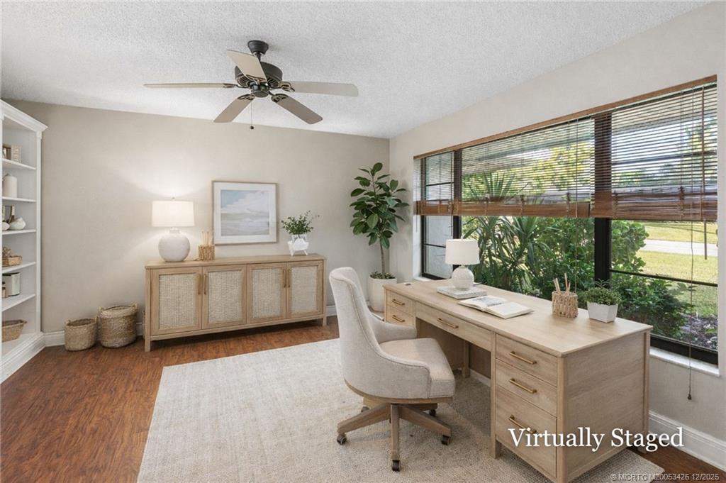 3181 Southeast Fairway West Stuart, FL 34997 - Photo 20 of 64 a living room with furniture a window and a chandelier