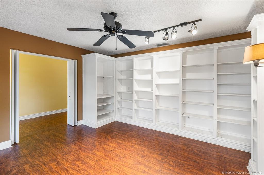 3181 Southeast Fairway West Stuart, FL 34997 - Photo 21 of 64 a view of an empty room with a window and wooden floor