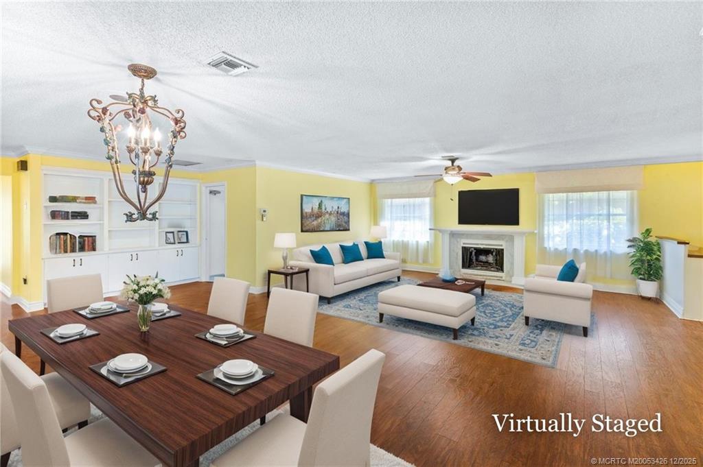 3181 Southeast Fairway West Stuart, FL 34997 - Photo 23 of 64 a living room with furniture and a chandelier