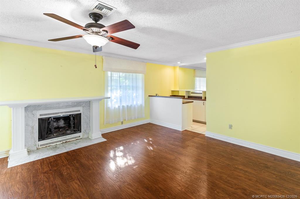 3181 Southeast Fairway West Stuart, FL 34997 - Photo 25 of 64 a view of a kitchen with a stove wooden floor and a fireplace