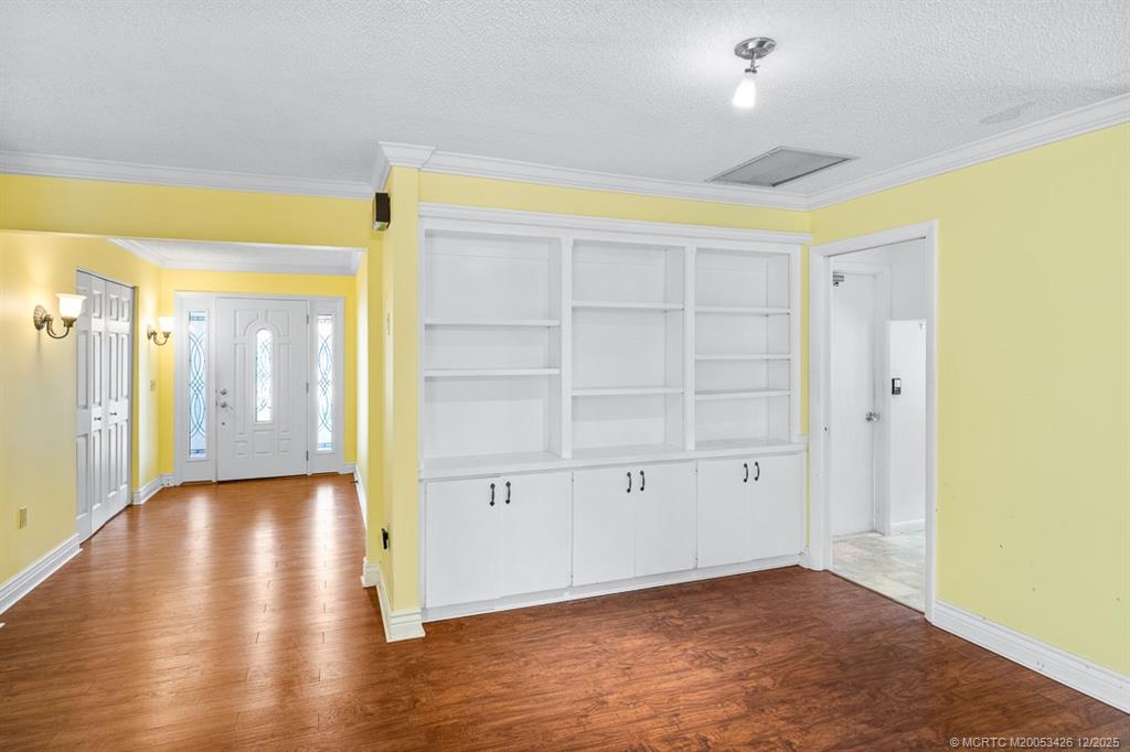 3181 Southeast Fairway West Stuart, FL 34997 - Photo 27 of 64 a view of an empty room with wooden floor and a window