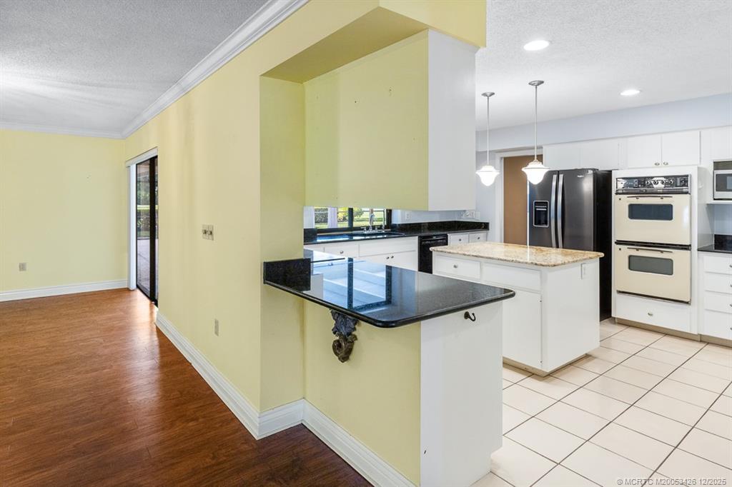 3181 Southeast Fairway West Stuart, FL 34997 - Photo 28 of 64 a kitchen with stainless steel appliances granite countertop a sink and a refrigerator