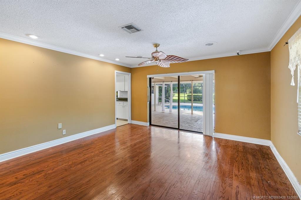 3181 Southeast Fairway West Stuart, FL 34997 - Photo 35 of 64 a view of an empty room with wooden floor and a window