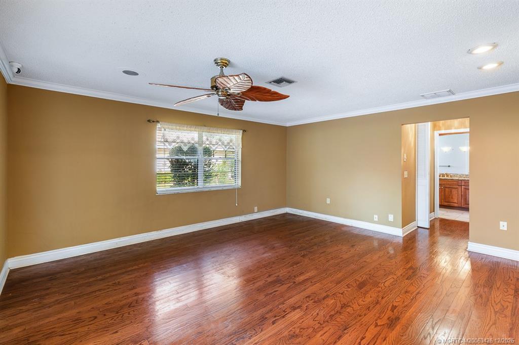 3181 Southeast Fairway West Stuart, FL 34997 - Photo 37 of 64 a view of an empty room with window and wooden floor