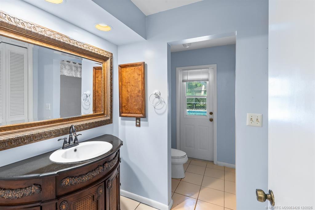 3181 Southeast Fairway West Stuart, FL 34997 - Photo 46 of 64 a bathroom with a sink and a mirror