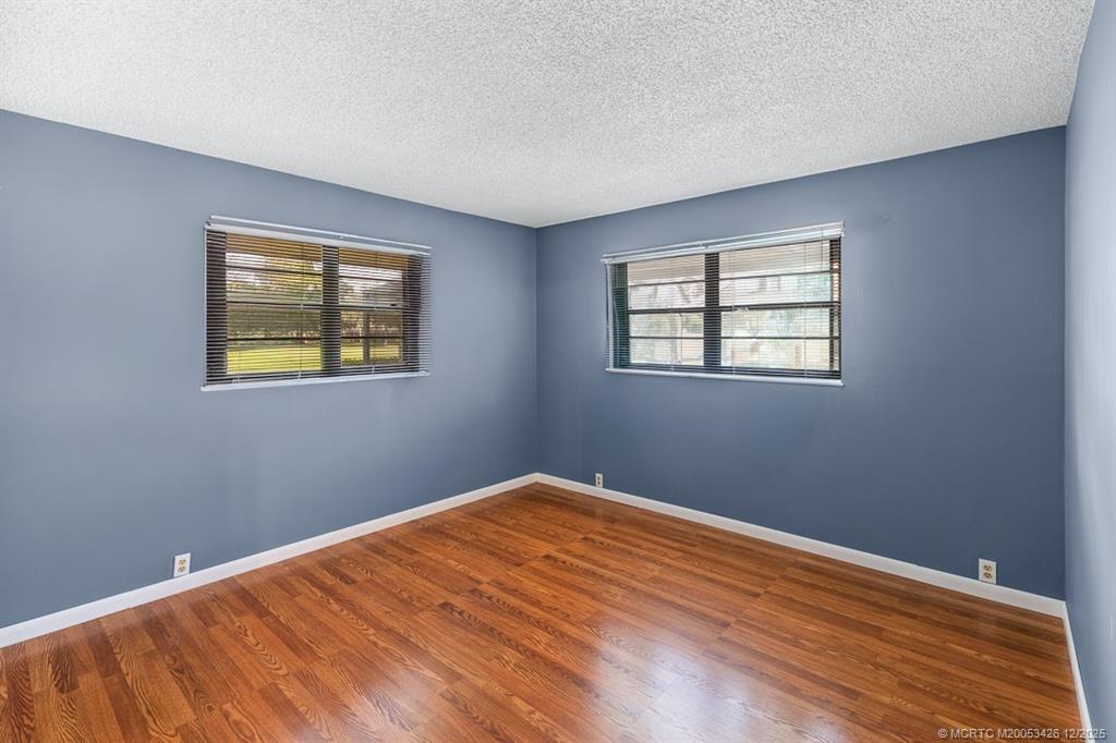3181 Southeast Fairway West Stuart, FL 34997 - Photo 48 of 64 a view of a big room with wooden floor and windows