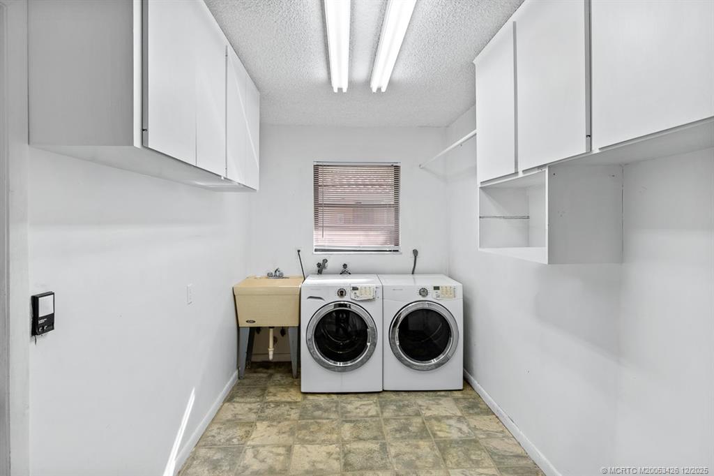 3181 Southeast Fairway West Stuart, FL 34997 - Photo 50 of 64 a utility room with dryer and washer
