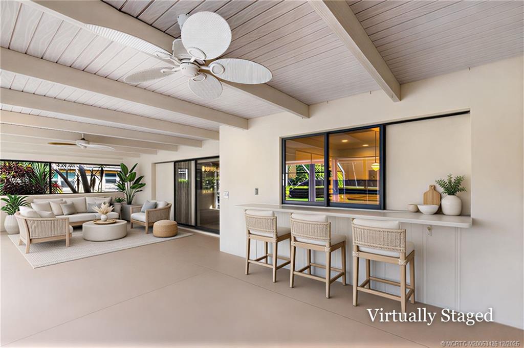 3181 Southeast Fairway West Stuart, FL 34997 - Photo 54 of 64 a living room with furniture and a large window