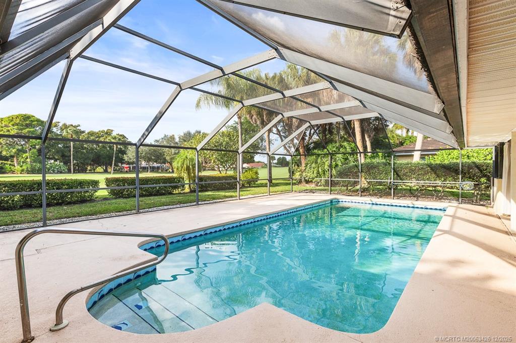 3181 Southeast Fairway West Stuart, FL 34997 - Photo 55 of 64 a view of a swimming pool with a porch and couches next to yard