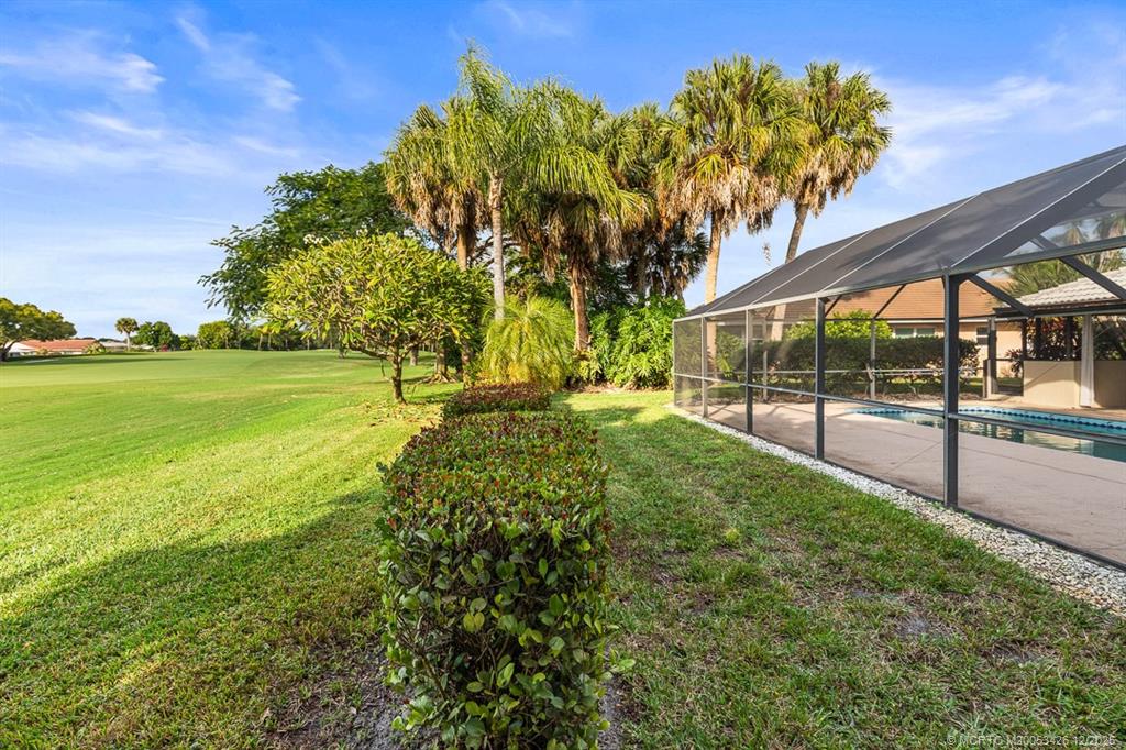 3181 Southeast Fairway West Stuart, FL 34997 - Photo 62 of 64 a view of yard with swimming pool and green space