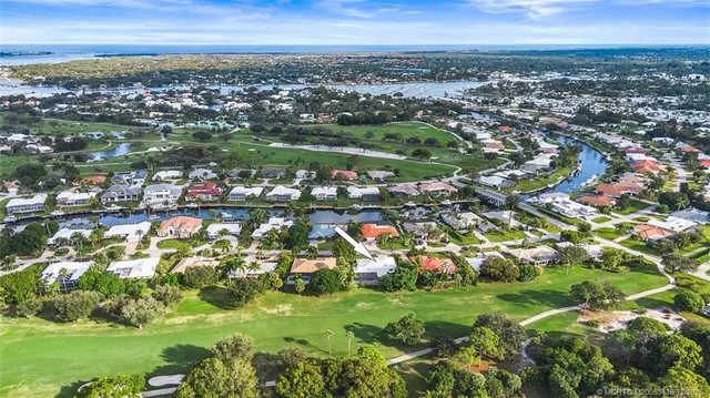 a view of a hallway with wooden floor and front door