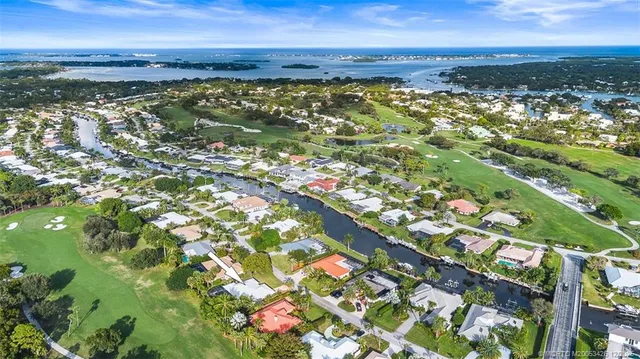a living room with furniture a window and a chandelier