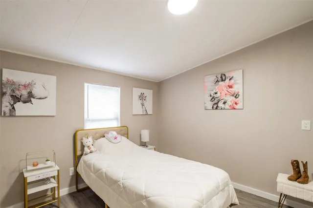 a bedroom with a bed and a wall painting