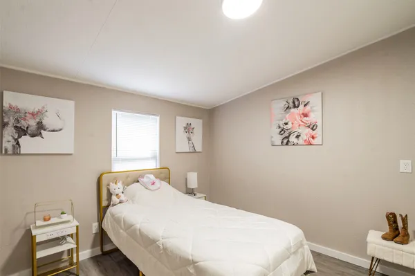 a bedroom with a bed and a wall painting