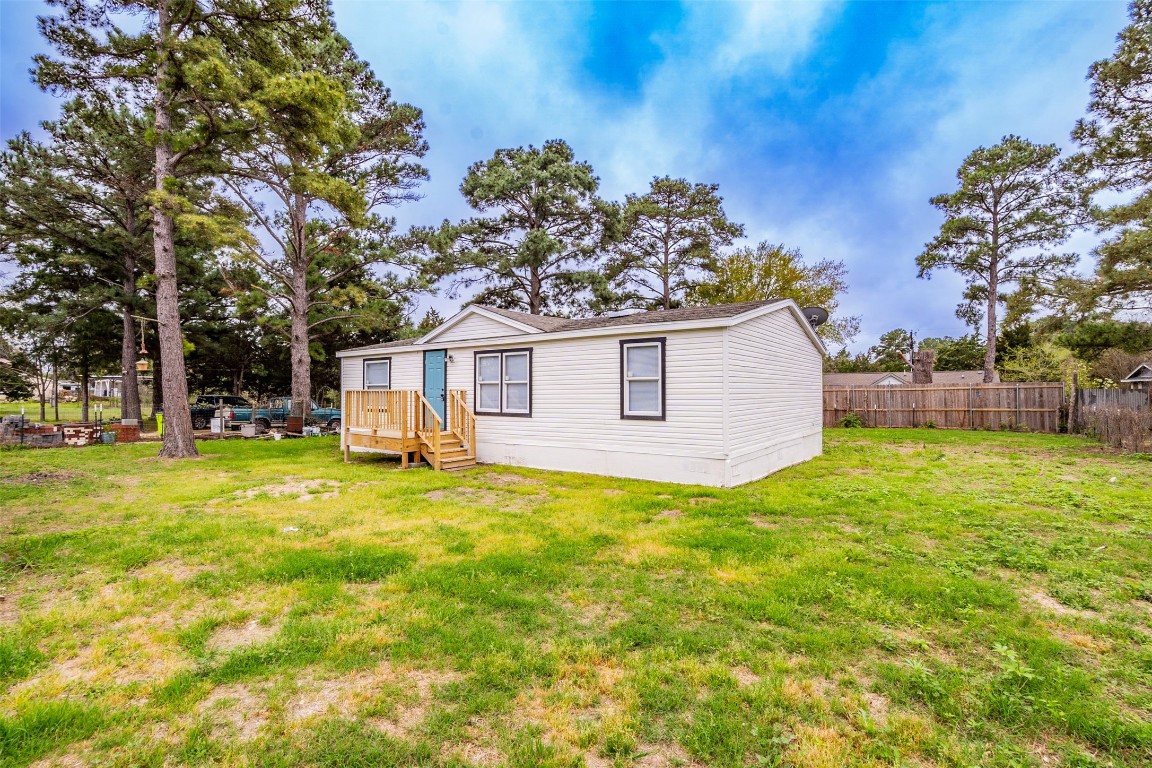 113 Sunset Ridge Bastrop, TX 78602 - Photo 13 of 15 a view of a house with backyard and tree