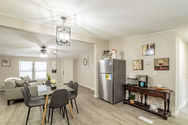 a view of a dining room with furniture and a chandelier