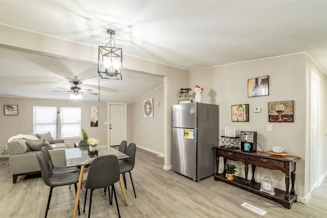 a view of a dining room with furniture and a chandelier