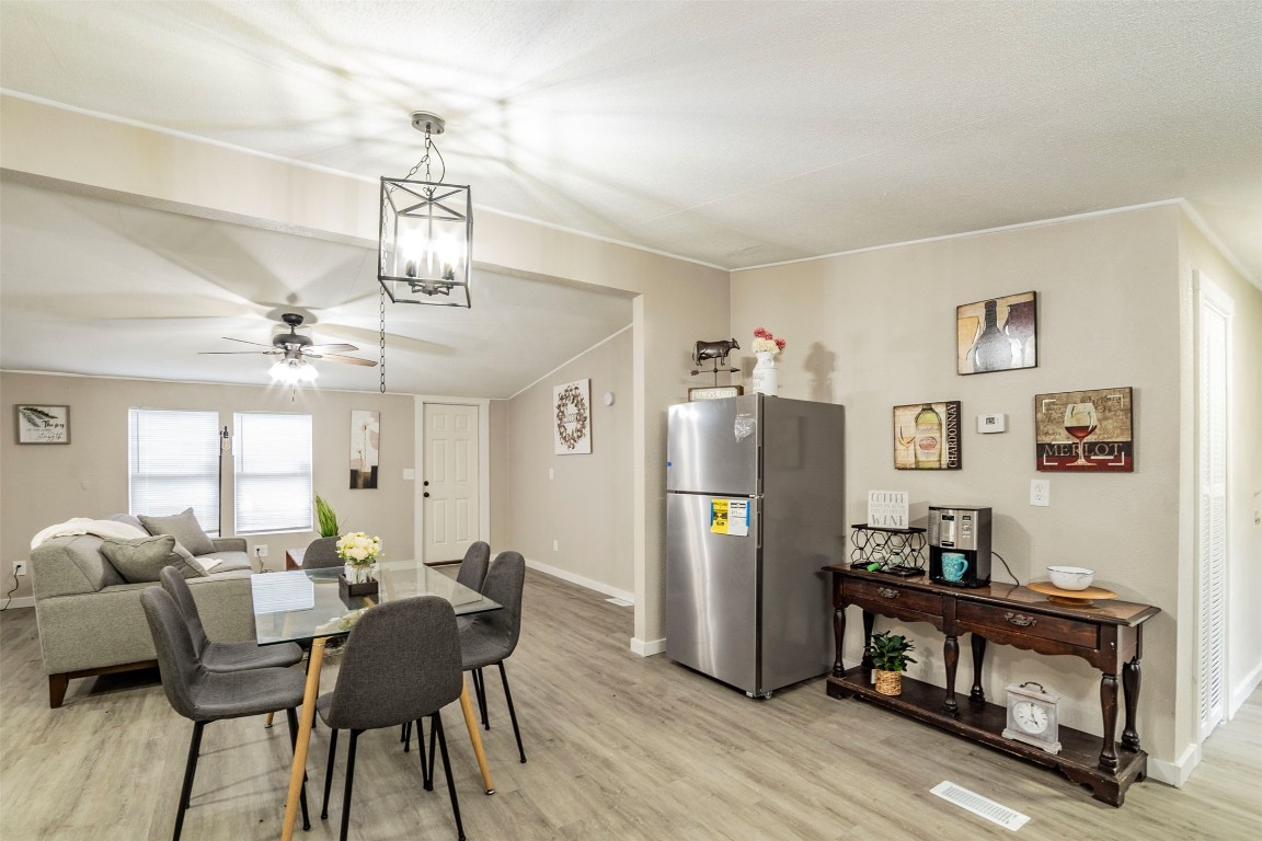 113 Sunset Ridge Bastrop, TX 78602 - Photo 6 of 15 a view of a dining room with furniture and a chandelier