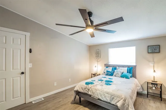 a bedroom with a bed and a ceiling fan