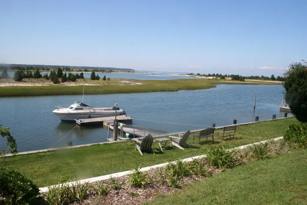 an aerial view of a house with a lake view and a yard