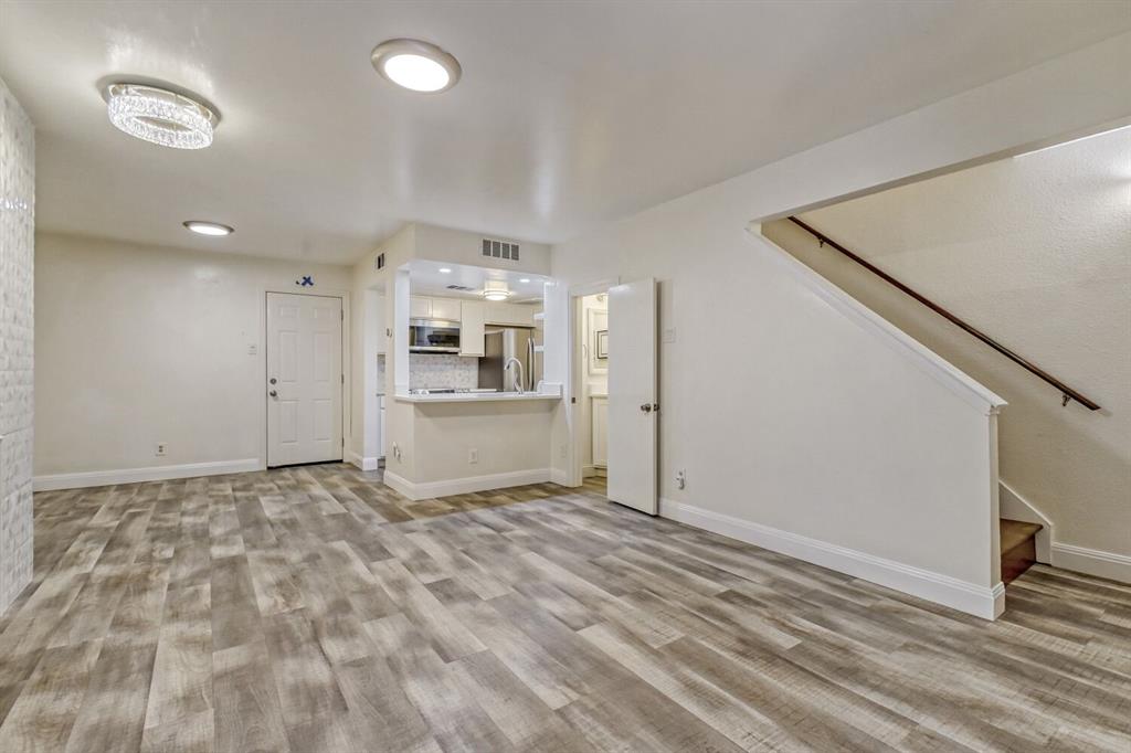 a view of a kitchen with a sink and a refrigerator