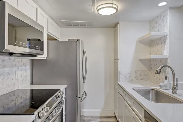 a kitchen with a refrigerator and a sink