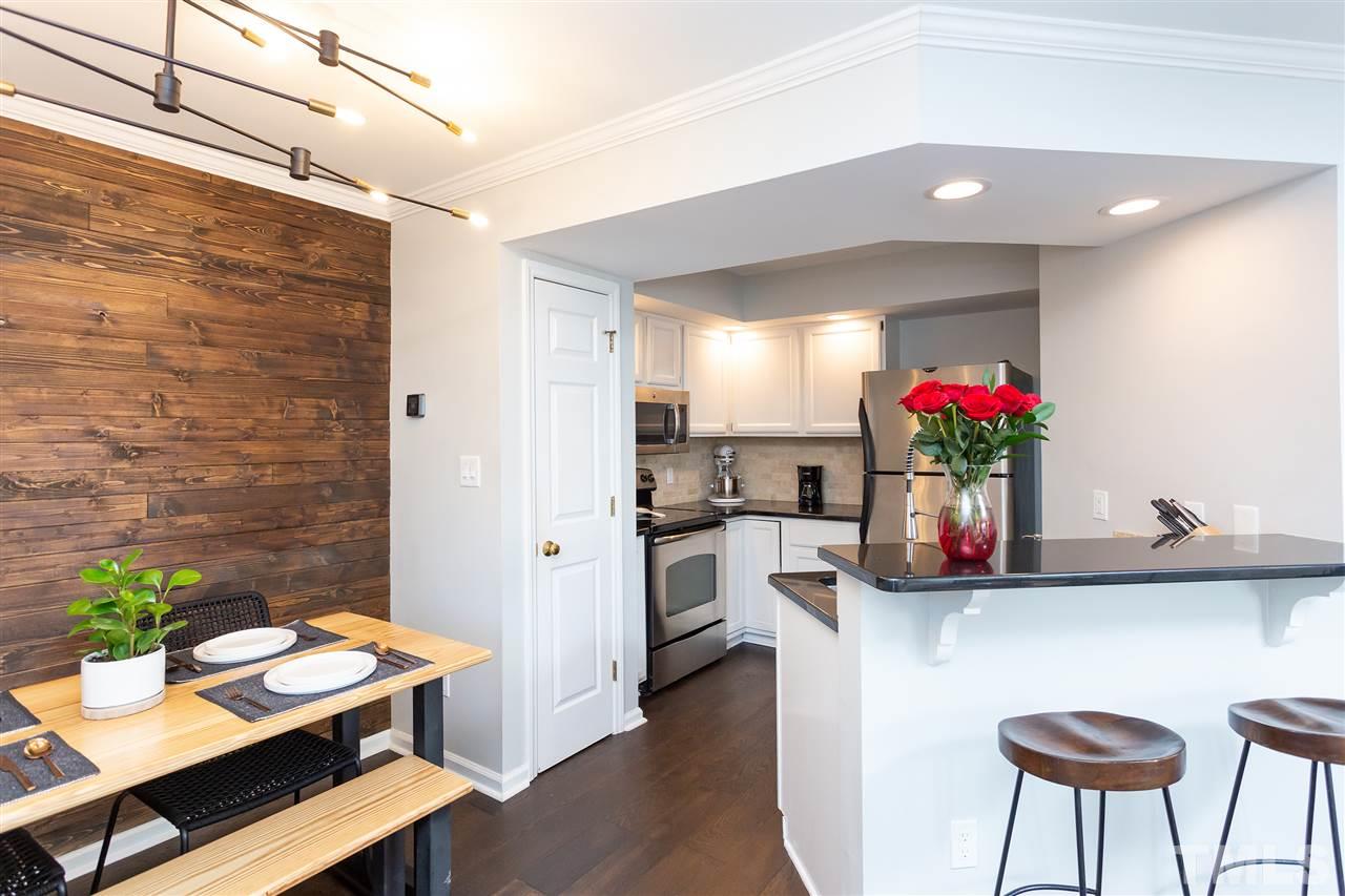 1462 Barton Pl Drive Raleigh, NC 27608 - Photo 15 of 25 a kitchen with a table and chairs in it