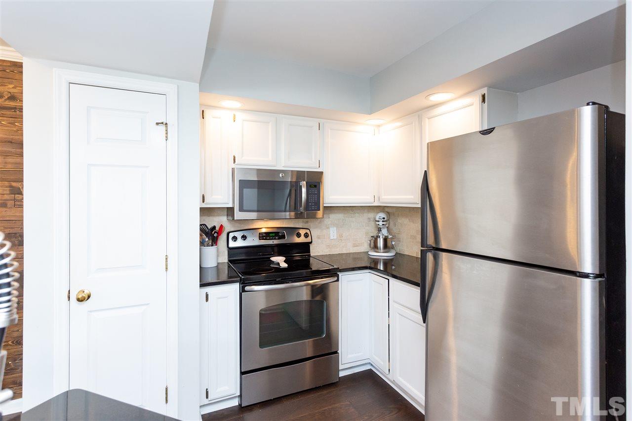 1462 Barton Pl Drive Raleigh, NC 27608 - Photo 16 of 25 a kitchen with a refrigerator stove and microwave