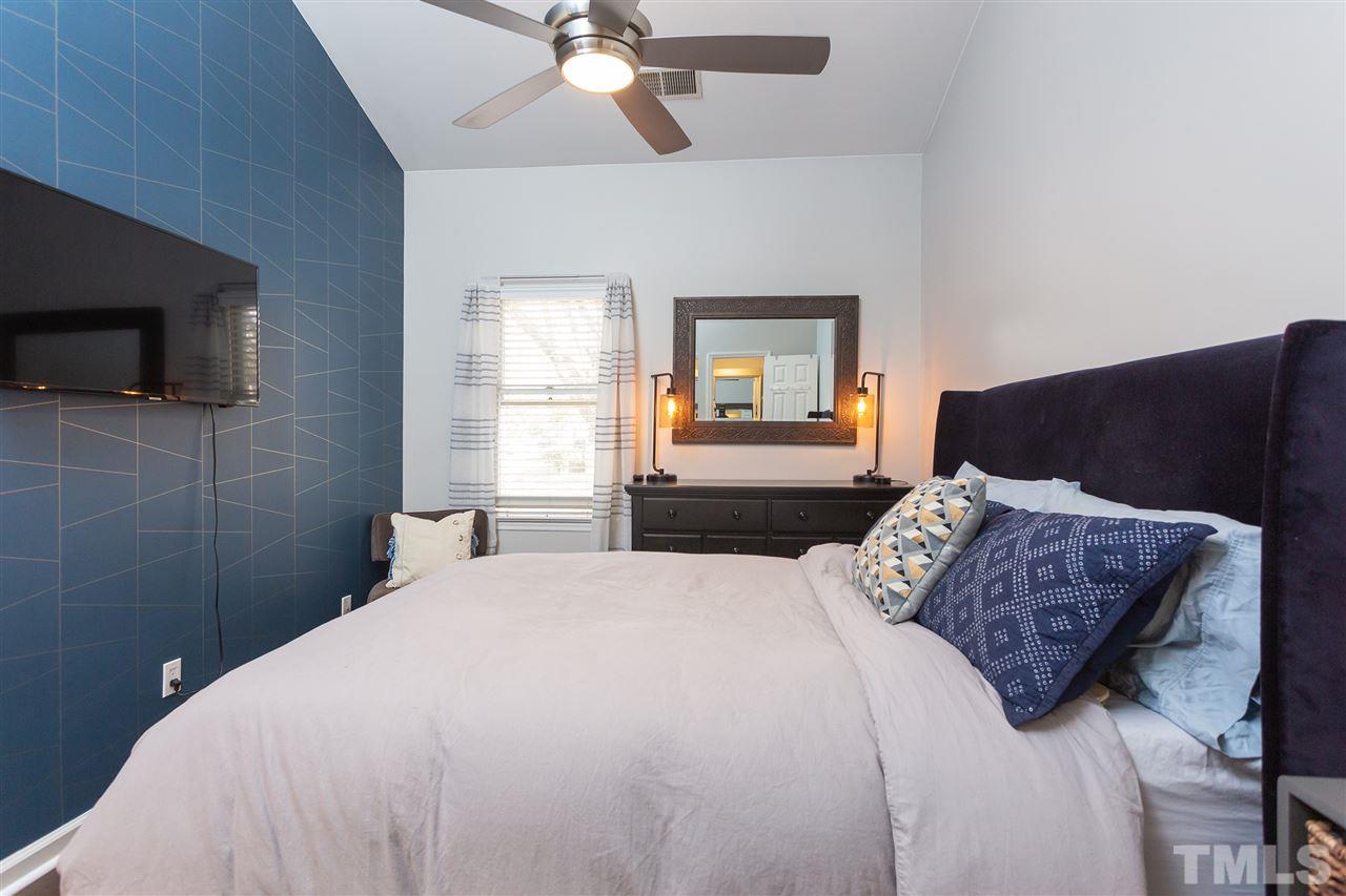 1462 Barton Pl Drive Raleigh, NC 27608 - Photo 19 of 25 a bedroom with a bed and a television