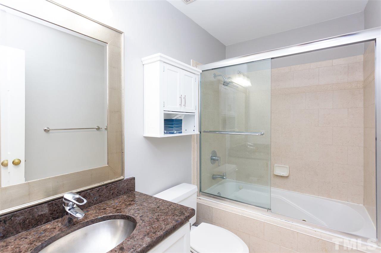 1462 Barton Pl Drive Raleigh, NC 27608 - Photo 20 of 25 a bathroom with a granite countertop sink toilet and shower