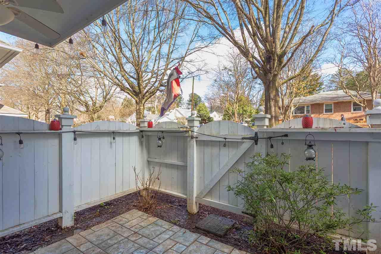 1462 Barton Pl Drive Raleigh, NC 27608 - Photo 25 of 25 a backyard of a house with large trees and plants