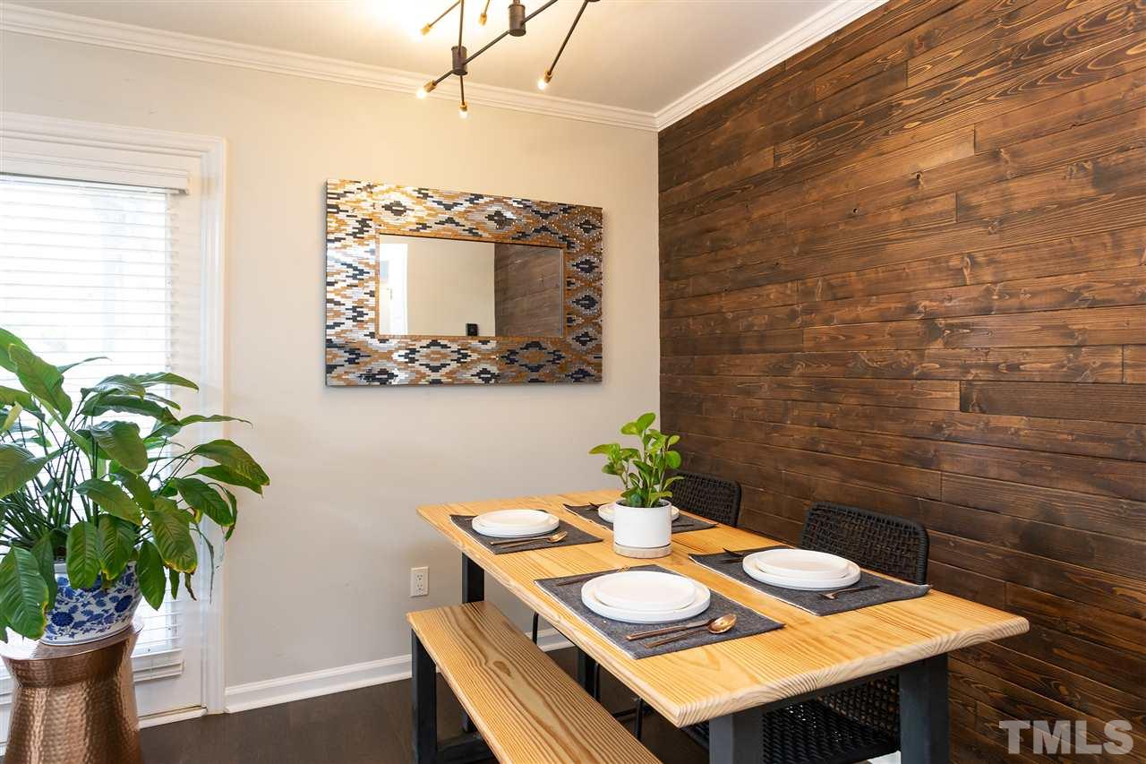 1462 Barton Pl Drive Raleigh, NC 27608 - Photo 9 of 25 a dining room with furniture and a potted plant