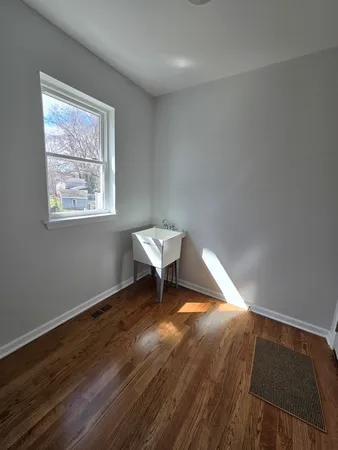 a workspace with wooden floor and a window