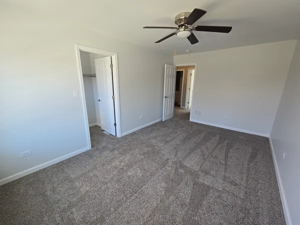 a view of empty room with ceiling fan