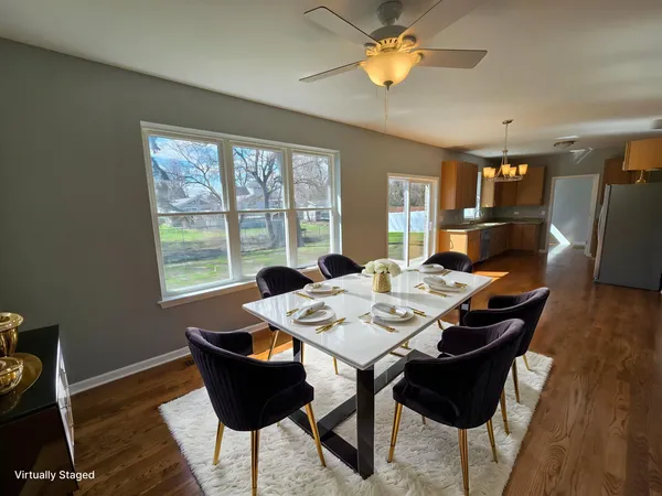 a view of a dining room with furniture and wooden floor