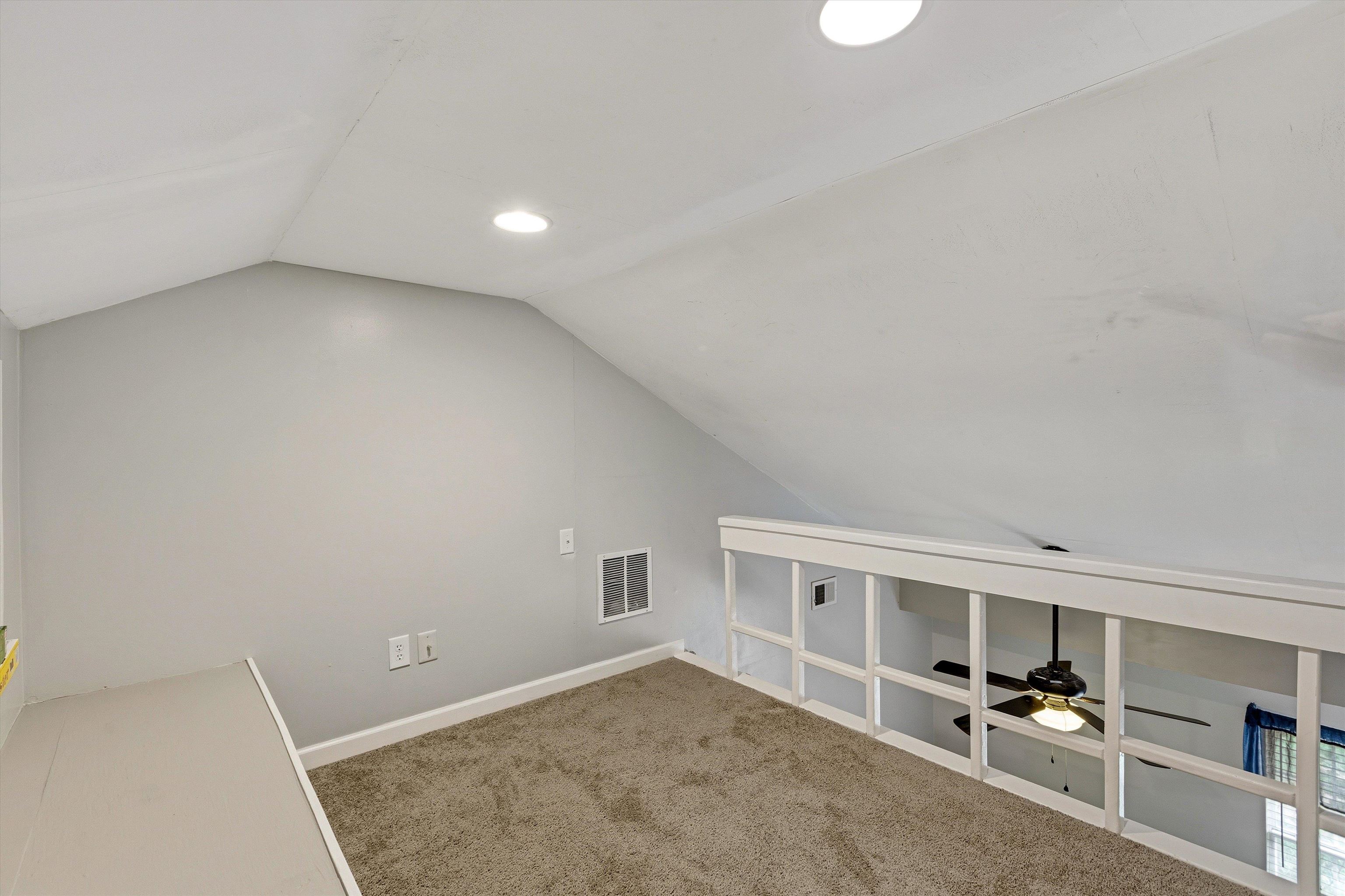 1379 Lagrange Downs Road Cordova, TN 38018 - Photo 28 of 35 Carpeted loft space featuring an angled ceiling, recessed lighting, and a white wood-frame railing overlooking the room below