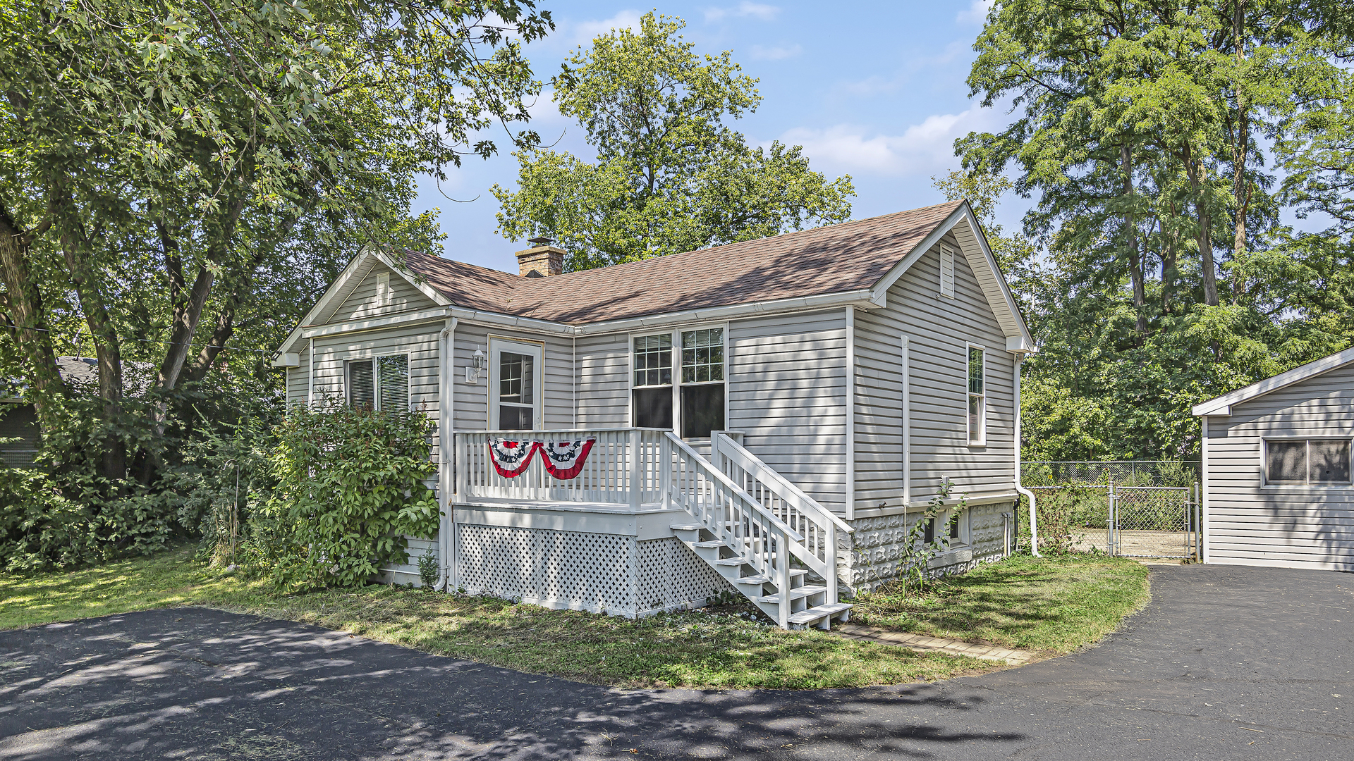 26058 West Rollins Road Ingleside, IL 60041 - Photo 1 of 18 a front view of a house with garden