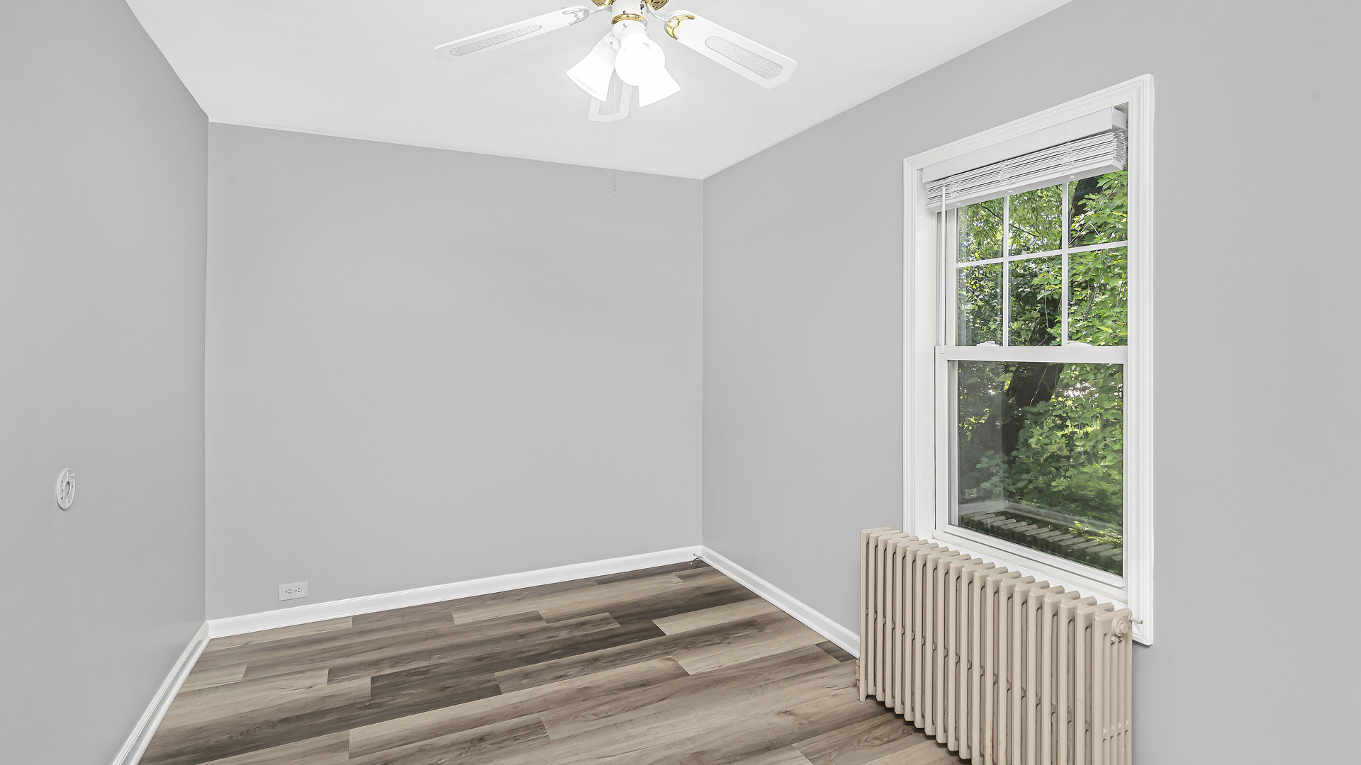 26058 West Rollins Road Ingleside, IL 60041 - Photo 12 of 18 an empty room with wooden floor fan and a window