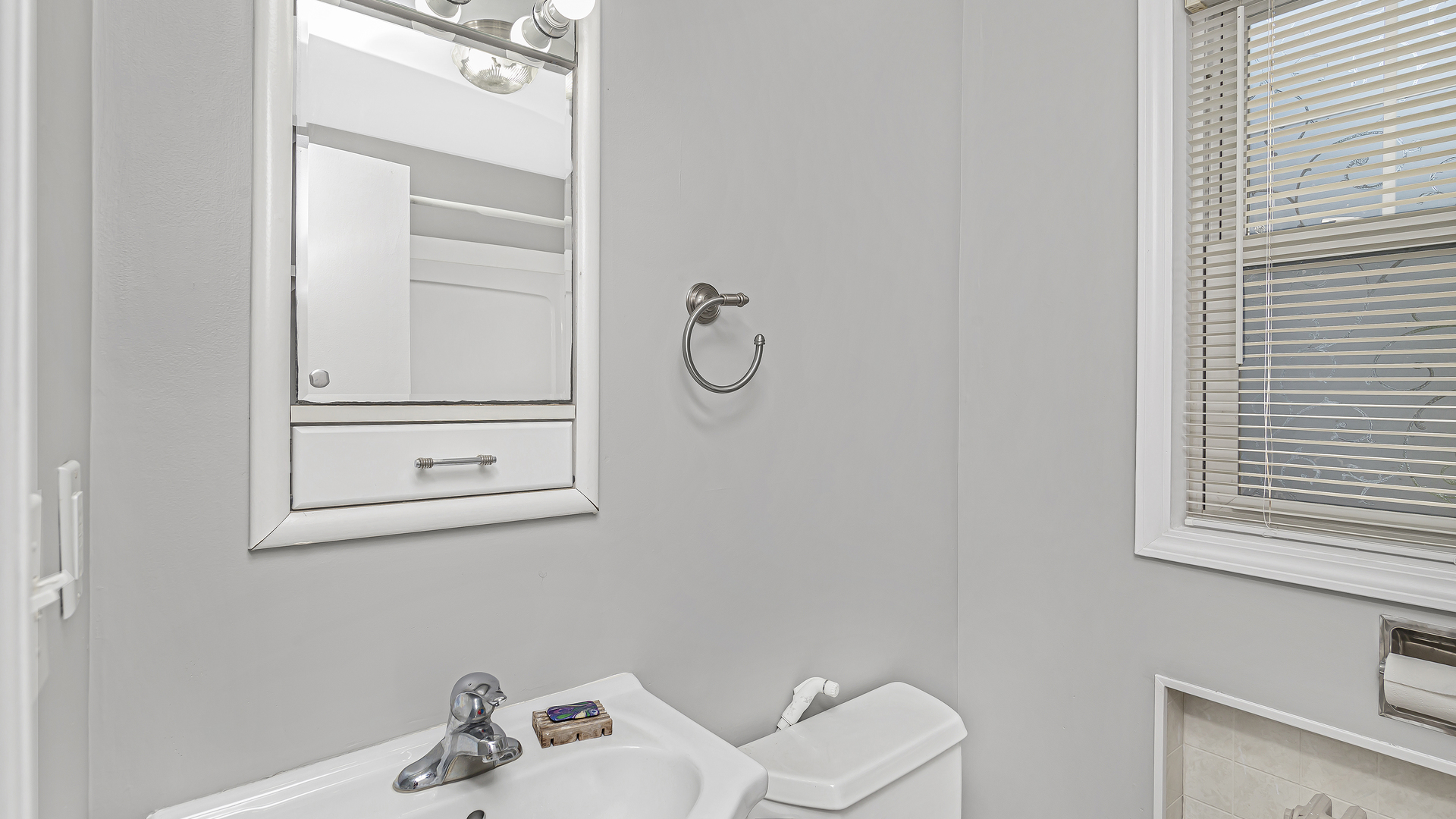 26058 West Rollins Road Ingleside, IL 60041 - Photo 13 of 18 a bathroom with a toilet sink and mirror