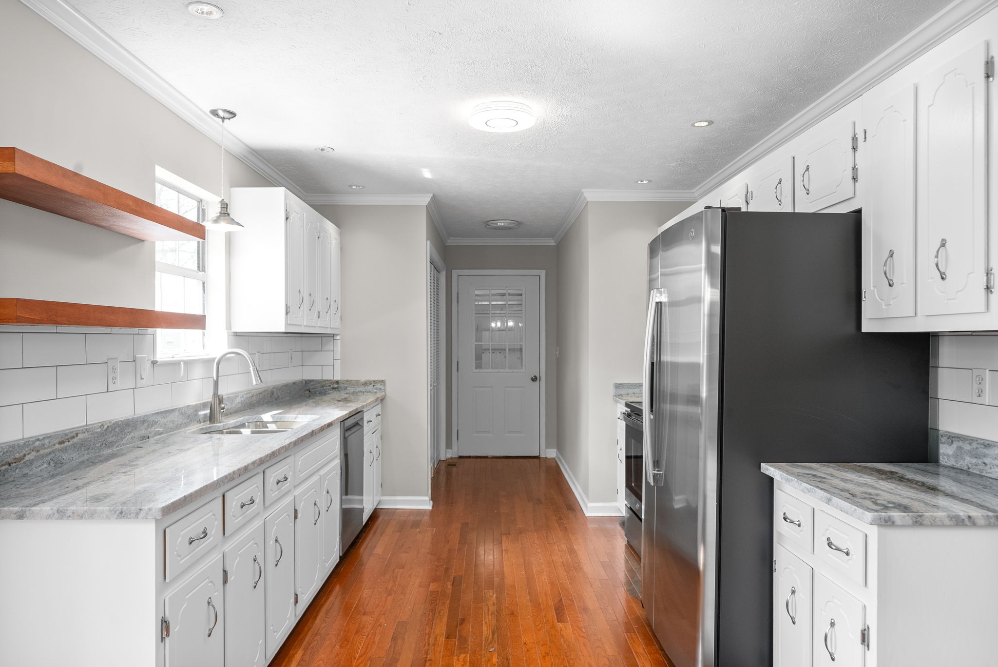 135 Carl Taylor Road Tennessee Ridge, TN 37178 - Photo 11 of 41 a kitchen with granite countertop a refrigerator a sink and dishwasher