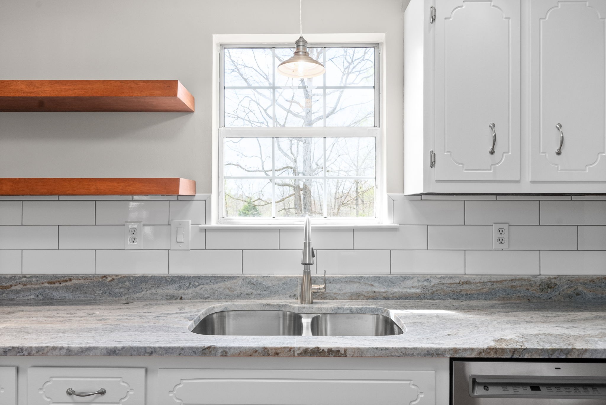 135 Carl Taylor Road Tennessee Ridge, TN 37178 - Photo 14 of 41 a kitchen with granite countertop a sink window and cabinets