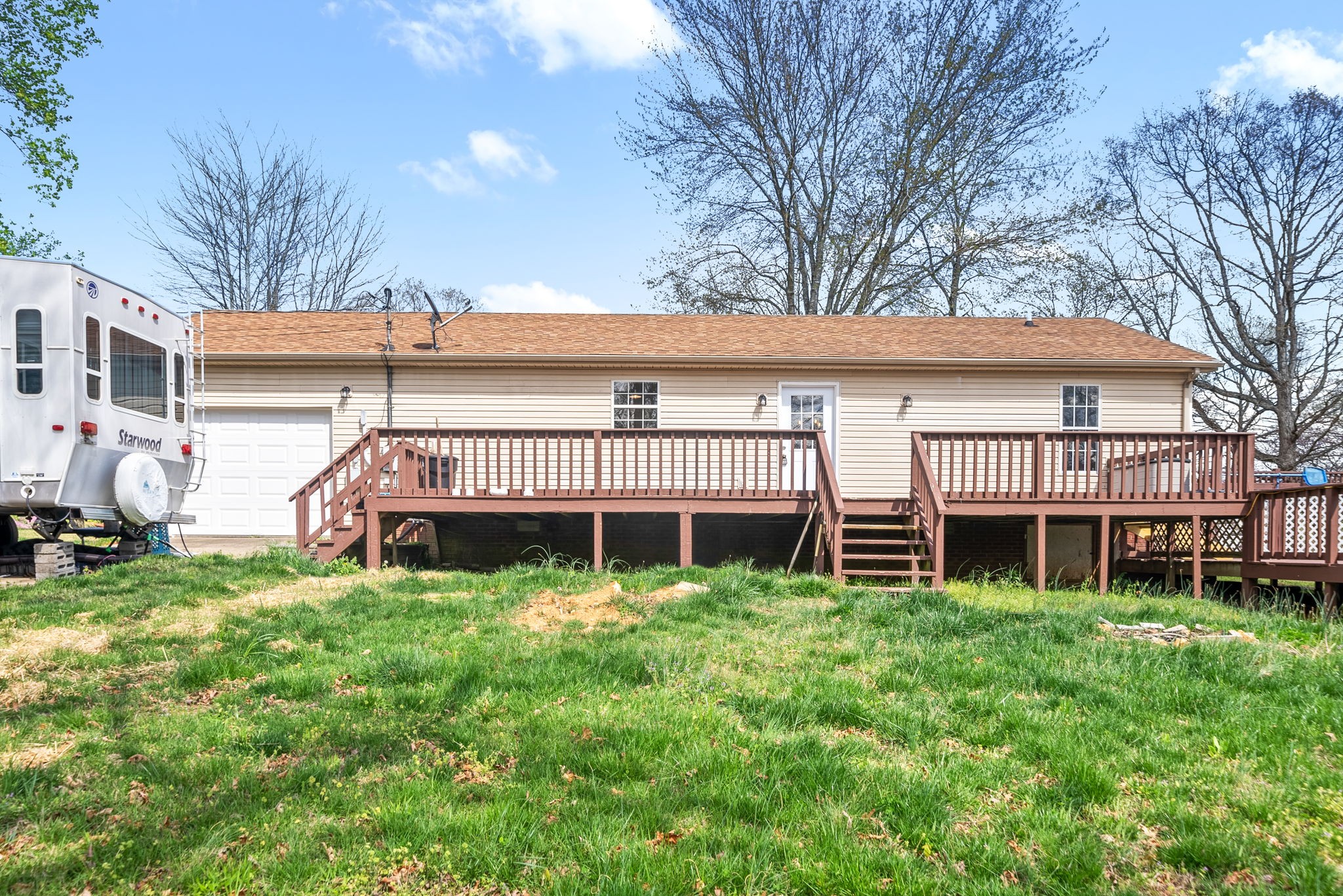 135 Carl Taylor Road Tennessee Ridge, TN 37178 - Photo 28 of 41 a view of a house with a big yard and large trees