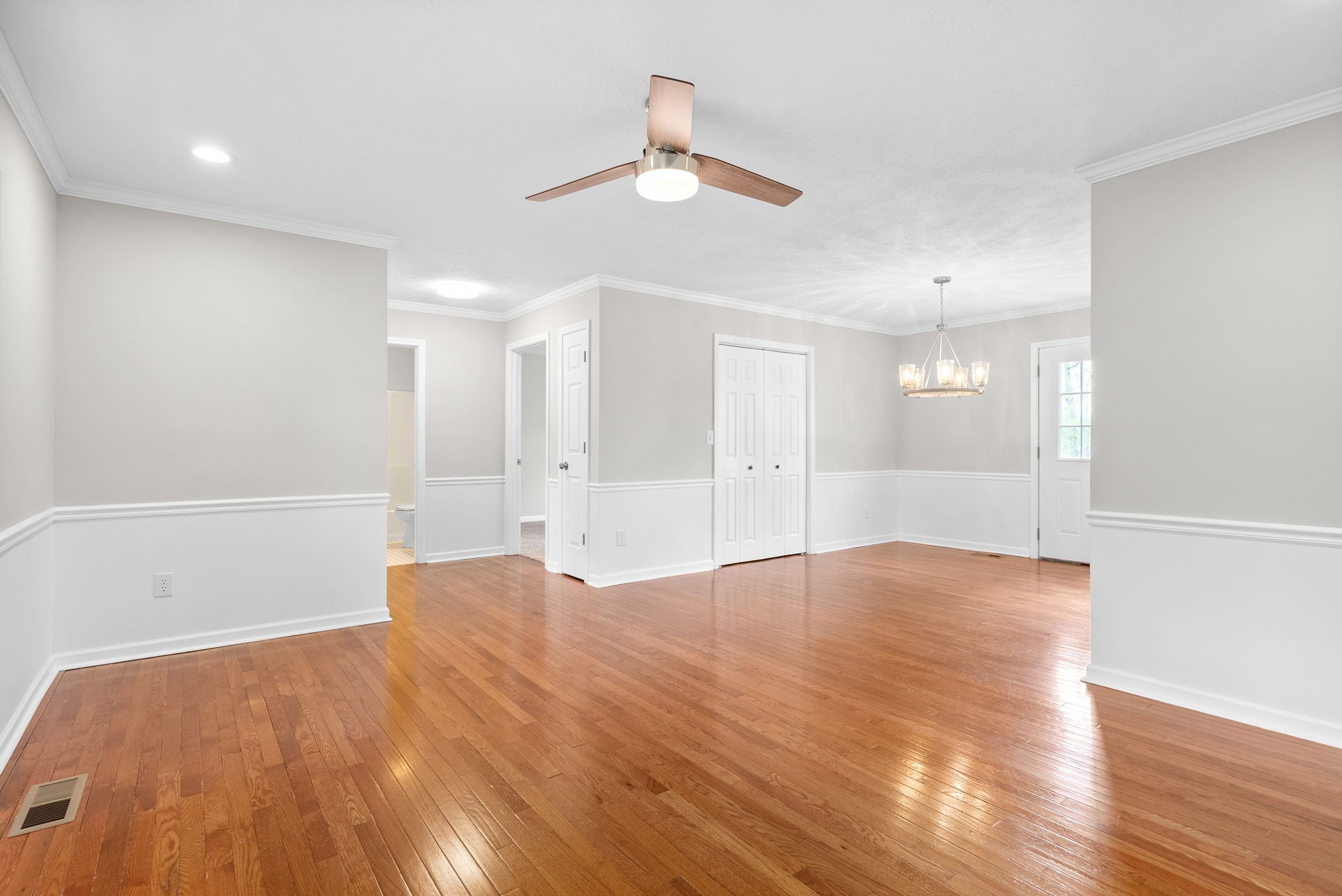 135 Carl Taylor Road Tennessee Ridge, TN 37178 - Photo 5 of 41 a view of an empty room with wooden floor and a ceiling fan