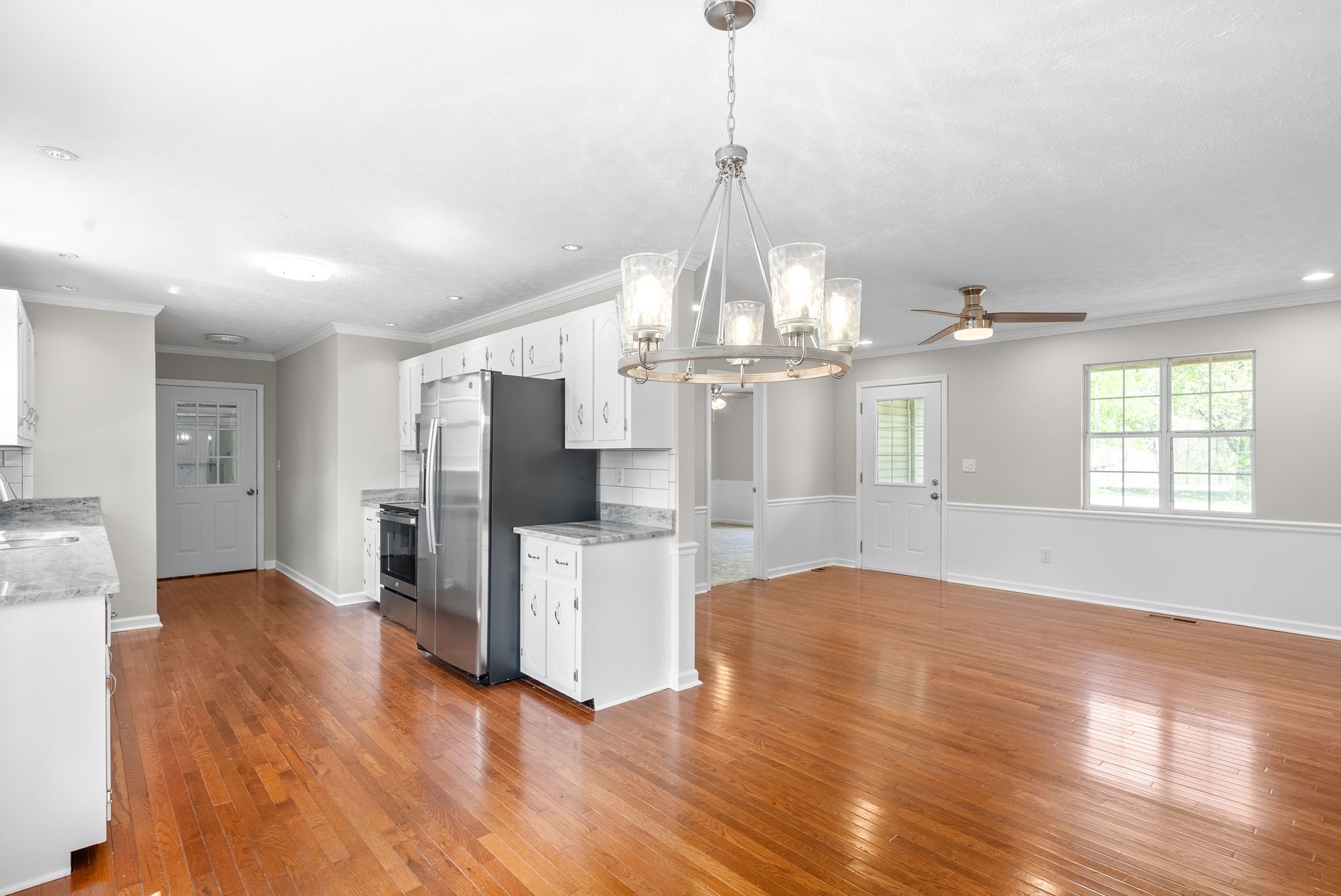 135 Carl Taylor Road Tennessee Ridge, TN 37178 - Photo 10 of 41 a view of a room with wooden floor fireplace and windows