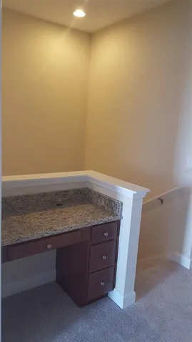 a view of room with granite countertop