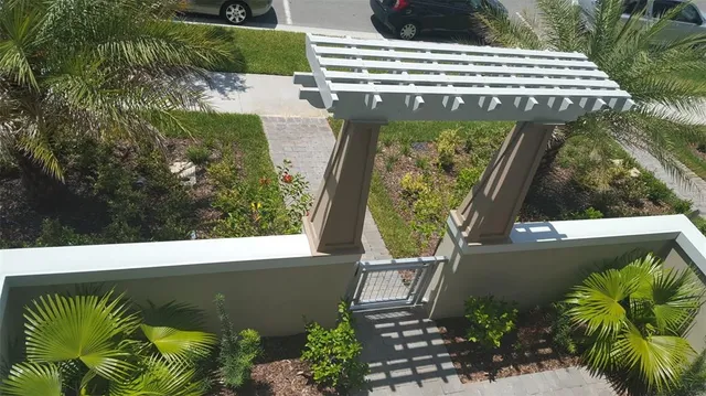 a view of a swimming pool with a patio and a yard