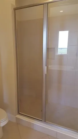 a bathroom with a glass shower door